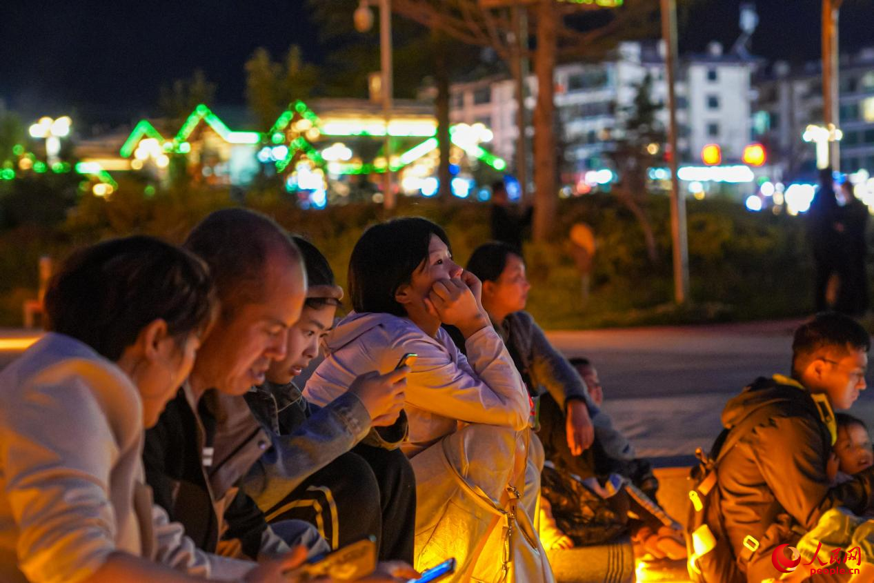 市民坐在西藏林芝市民族團(tuán)結(jié)廣場(chǎng)臺(tái)階上欣賞音樂噴泉。人民網(wǎng)記者 趙晨攝